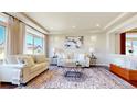 Sun-filled living room featuring a cozy sofa, stylish rug and large picture windows at 172 Painted Horse Way, Erie, CO 80516