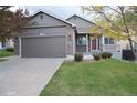 Charming single-Gathering home with a well-maintained lawn and a two-car garage, offering a welcoming curb appeal at 6123 S Quemoy Way, Aurora, CO 80015
