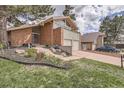 Brick home with a two-car garage and steps leading to the front door, complemented by landscaping at 2780 S Oakland W Cir, Aurora, CO 80014