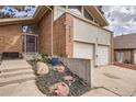 Charming brick facade home with a two-car garage, complemented by beautifully landscaped front yard at 2780 S Oakland W Cir, Aurora, CO 80014