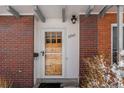 Close-up of a front door showcasing brick detail and a warm, welcoming entrance at 12543 W Alameda Dr, Lakewood, CO 80228