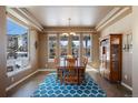 Elegant dining room featuring a large window with natural light and a stylish blue geometric rug at 1021 Neptunite Pl, Castle Rock, CO 80108