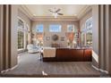 Spacious living room with large windows and a comfortable leather sectional at 1021 Neptunite Pl, Castle Rock, CO 80108