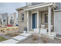 Inviting front porch with seating, modern planters, and views of the neighborhood at 12345 Festival Ln, Thornton, CO 80241