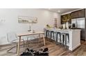 Open concept kitchen with breakfast bar, stainless steel appliances, and modern decor at 2036 S Vance Way, Lakewood, CO 80227