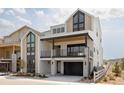 Modern two-story home with a black garage door, sleek balcony, and stylish architectural details at 11468 Alla Breve Cir, Lone Tree, CO 80134