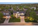 An aerial shot showcases the home's location within a neighborhood at 9810 Townsville Cir, Highlands Ranch, CO 80130