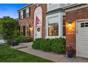 Close-up of a home's entrance with a charming walkway, lush landscaping, and a welcoming front door at 9810 Townsville Cir, Highlands Ranch, CO 80130