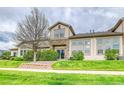 Back exterior of home with lawn, greenery, and an entrance sliding door at 23070 York Ave, Parker, CO 80138