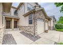 Charming townhome entry boasts stone accents, a double door entry and a lovely, low-maintenance front yard at 23070 York Ave, Parker, CO 80138
