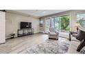 Cozy living room with a comfortable chair, large windows, and natural light at 2944 Zuni St # B, Denver, CO 80211