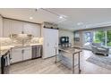 Bright living room with modern kitchen, stainless steel appliances, and an open floorplan at 2944 Zuni St # B, Denver, CO 80211