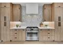 Kitchen showcases wood cabinets, a stainless steel range, and white backsplash tiles at 2800 S University Blvd # 170, Denver, CO 80210