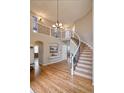 Spacious foyer featuring hardwood floors, staircase, and open balcony overlooking the living area at 10824 Quail Ridge Dr, Parker, CO 80138