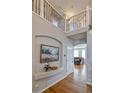 Elegant foyer with hardwood floors, decorative art niche, and open view to living spaces at 10824 Quail Ridge Dr, Parker, CO 80138