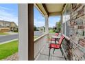 Cozy front porch with stone accents featuring outdoor seating and a view of the neighborhood at 282 Vialpando St, Brighton, CO 80601