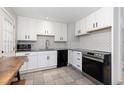 Bright kitchen featuring white cabinetry, subway tile backsplash, and modern appliances at 7286 Wolff St, Westminster, CO 80030