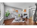 Cozy living room featuring hardwood floors, fireplace, and modern decor at 17698 E Loyola Dr # E, Aurora, CO 80013