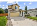 Attractive home with a stone facade, covered porch and a two-car garage with driveway at 10530 Mount Columbia Pl, Parker, CO 80138