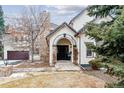 Charming front entrance featuring a stone archway and a black front door with sidelights at 215 Locust Ln, Denver, CO 80220