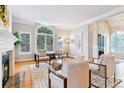 Elegant living room with a fireplace, hardwood floors, and large windows with custom shutters at 215 Locust Ln, Denver, CO 80220