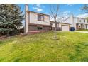 Two-story home featuring a well-manicured front lawn with a brick facade at 10550 Routt St, Westminster, CO 80021