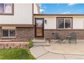 A well-maintained front exterior featuring brick accents and an outdoor seating area at 10550 Routt St, Westminster, CO 80021