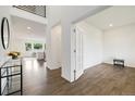 Inviting foyer with beautiful hardwood floors, high ceilings, and a view into the bright and airy living spaces at 6692 S Robertsdale Way, Aurora, CO 80016