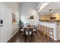 Dining room featuring a table, six chairs, and modern lighting adjoining the kitchen area at 6450 W 44Th Pl # B3, Wheat Ridge, CO 80033
