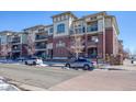 Well-maintained condominium complex with brick and siding, enhanced by private balconies and tidy landscaping at 3872 S Dallas St # 7-307, Aurora, CO 80014