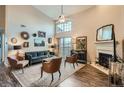 Bright living room boasts vaulted ceilings, a cozy fireplace, and access to a private balcony at 3872 S Dallas St # 7-307, Aurora, CO 80014