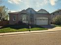 Charming single-story home with brick facade, attached garage, and manicured front lawn at 11144 Navajo St, Northglenn, CO 80234