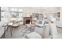 Bright living room featuring a brick fireplace, large windows, and modern neutral-tone furniture at 11144 Navajo St, Northglenn, CO 80234