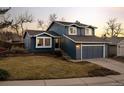 Charming two-story home with a well-maintained lawn and two-car garage at 322 Mountain Cloud Cir, Highlands Ranch, CO 80126