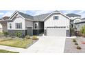 Charming single-Gathering home showcasing a stone accents, well-manicured lawn, and a two-car garage at 20272 Terrace View Dr, Parker, CO 80134