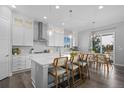 An open kitchen features quartz countertops, stainless steel appliances, and a breakfast bar with seating at 20272 Terrace View Dr, Parker, CO 80134