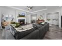 Spacious living room showcasing a fireplace, large sectional, and an open floorplan at 20272 Terrace View Dr, Parker, CO 80134
