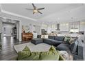 An open-concept living room featuring wood floors, and an adjoining kitchen with stainless steel appliances at 20272 Terrace View Dr, Parker, CO 80134