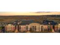 A view of the condo complex and landscape, featuring ponds, hills, and city view at 13456 Via Varra # 428, Broomfield, CO 80020