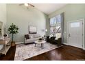 Bright living room with soaring ceilings, large windows, and hardwood floors at 19632 E Bethany Dr, Aurora, CO 80013