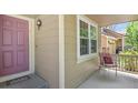 Inviting front porch with seating and a welcoming entrance at 17332 E Lake Ln, Aurora, CO 80016