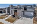 Contemporary exterior boasts unique architecture, stone accents, and a well-manicured landscape at 7125 Skygazer St, Castle Pines, CO 80108