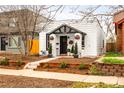 Quaint home exterior featuring a well-kept yard, mature trees, and inviting entrance at 1452 S Logan St, Denver, CO 80210
