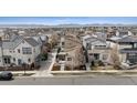 Stunning aerial view of a neighborhood with mountain backdrop, showcasing community layout and surrounding area at 6631 Alan Dr, Denver, CO 80221