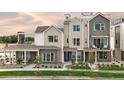 Attractive three-story townhomes featuring brick accents, modern design, and individual entrances at 888 S Valentia St # 102, Denver, CO 80247