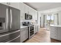Well-lit kitchen boasting modern cabinets, stainless steel appliances, and a cozy dining area at 888 S Valentia St # 102, Denver, CO 80247