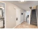 Bright entryway with tile flooring, staircase, and powder room at 1475 S Quebec Way # H38, Denver, CO 80231