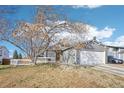 A cozy single-Gathering home featuring a well-manicured lawn and inviting front porch at 19003 E Oxford Dr, Aurora, CO 80013