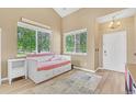 Sunlit room featuring a trundle daybed, light wood floors, and bright decor at 19463 E Hollow Creek Dr, Parker, CO 80134