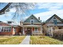 Charming two-story red brick home with a covered front porch and walkway at 2146 Federal Blvd, Denver, CO 80211